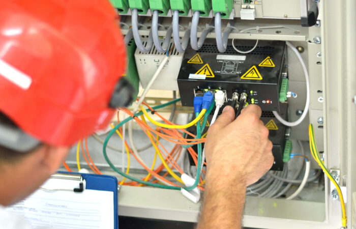 Engineer Connecting Fiber Optic Cable to the Switch 599755052 3431x2908